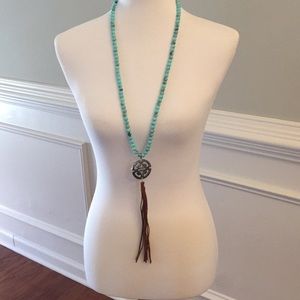 Macy’s long turquoise bead necklace.